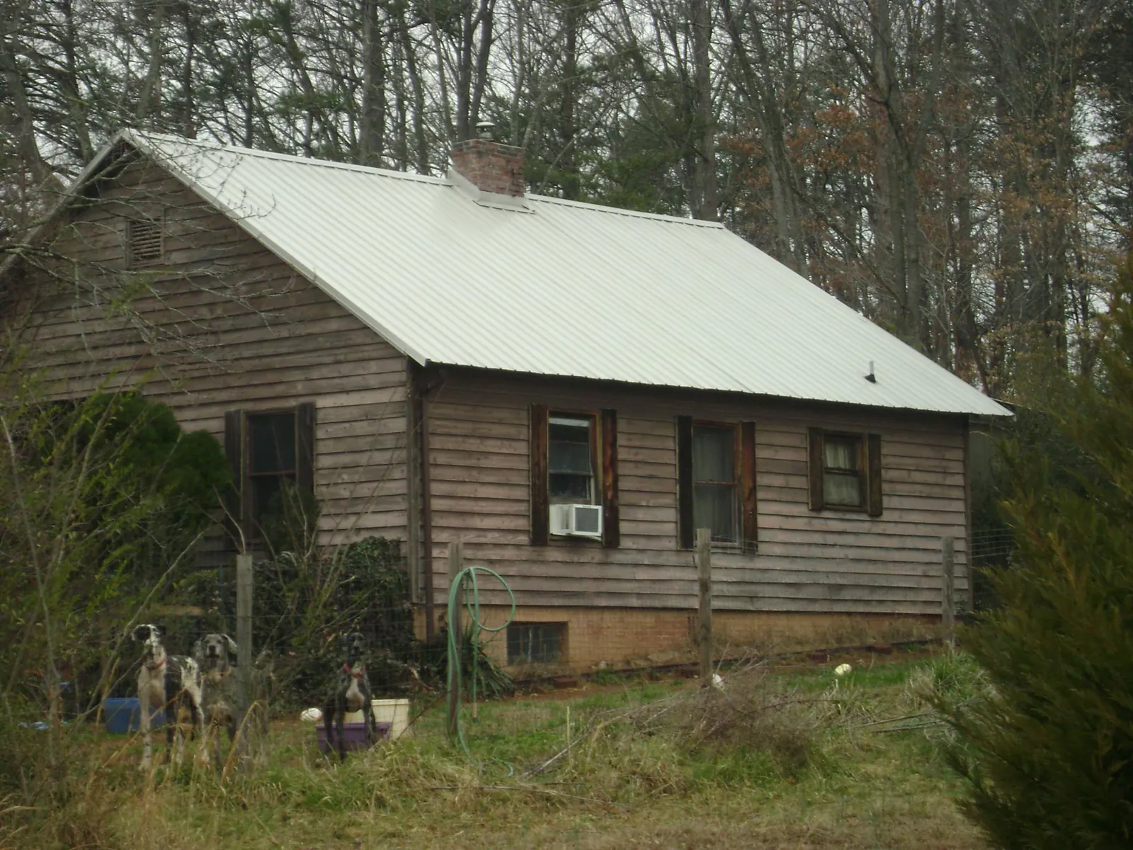 White metal roof on an old wood sided farmhouse, from a Metal Roof Installation job in Cherry Plain